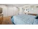 Bedroom view features a bed, blue bench, and multiple closets leading to bathroom with vanity and sink at 3832 S Quebec St, Denver, CO 80237