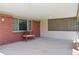 Relaxing covered patio area with a wooden bench and concrete flooring at 3832 S Quebec St, Denver, CO 80237