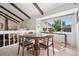 Cozy dining area with a round table, ample seating, natural light, and a view of the backyard at 3832 S Quebec St, Denver, CO 80237