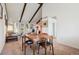 Inviting dining room featuring exposed beams and is part of the open floor plan at 3832 S Quebec St, Denver, CO 80237