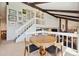 Open dining area with views to the living room and staircase at 3832 S Quebec St, Denver, CO 80237