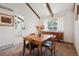 Inviting dining room featuring exposed beams and has a large window that provides lots of natural light at 3832 S Quebec St, Denver, CO 80237