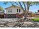 Charming two-story home with brick accents, attached garage, mature tree, and well-maintained lawn at 3832 S Quebec St, Denver, CO 80237
