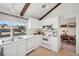 Clean white kitchen with modern appliances and a view to the neighborhood at 3832 S Quebec St, Denver, CO 80237