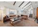 Bright living room with open floor plan and exposed ceiling beams at 3832 S Quebec St, Denver, CO 80237