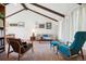 Bright living room featuring vaulted ceilings, exposed beams, neutral tones, and lots of natural light at 3832 S Quebec St, Denver, CO 80237