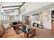 Expansive living room with staircase and access to the dining area at 3832 S Quebec St, Denver, CO 80237