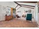Spacious living room with vaulted ceilings, exposed beams, lots of wall art, and comfortable seating at 3832 S Quebec St, Denver, CO 80237