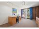Office space with a large desk, natural light, and views of the neighborhood at 3832 S Quebec St, Denver, CO 80237