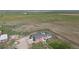 Aerial shot of a red home on a large lot with a green field at 66095 E Kettle Pl, Byers, CO 80103
