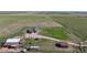 Aerial view of red home and outbuildings on a sprawling lot at 66095 E Kettle Pl, Byers, CO 80103