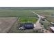 Aerial view of a rural property with a red home and expansive land at 66095 E Kettle Pl, Byers, CO 80103