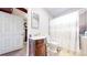 Bathroom featuring vintage vanity, a combination shower and tub, and adjacent linen closet at 66095 E Kettle Pl, Byers, CO 80103