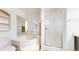 Bright bathroom with a corner tub, separate shower, and mirrored walls at 66095 E Kettle Pl, Byers, CO 80103