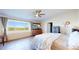 Bedroom with ceiling fan, dresser, and large window with view at 66095 E Kettle Pl, Byers, CO 80103