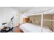 Comfortable bedroom with white-painted bunkbeds, stationary bike, and sleek hardwood flooring at 66095 E Kettle Pl, Byers, CO 80103