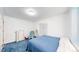 Cozy bedroom with blue carpet, featuring a comfy chair and a classic dresser at 66095 E Kettle Pl, Byers, CO 80103