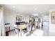 Open dining room with stylish table and seating, seamlessly connected to the kitchen at 66095 E Kettle Pl, Byers, CO 80103