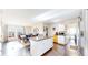 Open kitchen and dining layout, complete with stainless steel refrigerator and island seating at 66095 E Kettle Pl, Byers, CO 80103