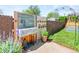 Backyard featuring a gardening station, potted plants, and a metal gardening bed at 4163 S Decatur St, Englewood, CO 80110