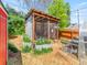 Backyard featuring a chicken coop, metal gardening beds and a wood chip yard at 4163 S Decatur St, Englewood, CO 80110
