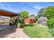 Relaxing backyard with patio, outdoor dining area, tool shed, and greenhouse at 4163 S Decatur St, Englewood, CO 80110