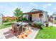 Backyard patio with a glass top table, chairs, and garden with flowers at 4163 S Decatur St, Englewood, CO 80110