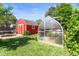 Landscaped backyard boasts a tool shed, greenhouse, and lush green grass at 4163 S Decatur St, Englewood, CO 80110