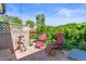 Outdoor patio features lush greenery, red lounge chairs, and relaxing backyard at 4163 S Decatur St, Englewood, CO 80110