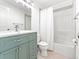 Bathroom featuring a modern vanity with granite countertops, shower over tub, and tile floor at 4163 S Decatur St, Englewood, CO 80110