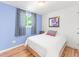 Bright bedroom with accent wall and hardwood floors at 4163 S Decatur St, Englewood, CO 80110