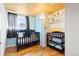 Bright Bedroom features hardwood floors, a wood ceiling, and ample storage space for baby essentials at 4163 S Decatur St, Englewood, CO 80110