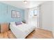 Cozy bedroom featuring a brightly painted accent wall and a large window at 4163 S Decatur St, Englewood, CO 80110