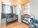 Well-lit bedroom with slatted wood ceiling, light-blue walls, and dark-wood furniture at 4163 S Decatur St, Englewood, CO 80110