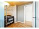 Functional Bedroom area with hardwood floors, storage shelves, and easy access to the closet at 4163 S Decatur St, Englewood, CO 80110