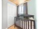 Bedroom with hardwood floors, whitewashed walls, and large white closets at 4163 S Decatur St, Englewood, CO 80110