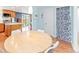 Dining area with kitchen view features hardwood floors, stylish seating, and sliding door access at 4163 S Decatur St, Englewood, CO 80110