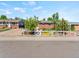 Charming single-story home with a red brick facade, blue shutters, and a white picket fence at 4163 S Decatur St, Englewood, CO 80110