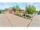 Charming brick home with a fenced-in garden and mature trees under a blue sky at 4163 S Decatur St, Englewood, CO 80110