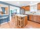 Open concept kitchen area with island and stainless steel appliances, and view to the dining room at 4163 S Decatur St, Englewood, CO 80110