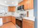 Kitchen features wooden cabinets, stainless steel appliances, and quartz countertops at 4163 S Decatur St, Englewood, CO 80110