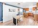 Bright kitchen with eat-in breakfast nook open to living area and built-in custom storage at 4163 S Decatur St, Englewood, CO 80110