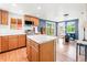 Spacious kitchen features wood cabinets, stainless steel appliances, and an island with a white countertop at 4163 S Decatur St, Englewood, CO 80110