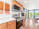 Kitchen showcases stainless steel oven and microwave with wood cabinets and views to the outside at 4163 S Decatur St, Englewood, CO 80110