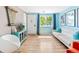 Bright living room showcasing hardwood floors, a modern white sofa, and natural light from the window at 4163 S Decatur St, Englewood, CO 80110