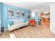 Bright living room featuring wood floors, modern furnishings, and an open layout to the kitchen at 4163 S Decatur St, Englewood, CO 80110