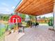 Covered brick patio with outdoor seating and a red storage shed in the background at 4163 S Decatur St, Englewood, CO 80110