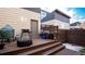 Inviting backyard wood deck with steps, grill, outdoor seating, and privacy fence at 2870 W Parkside Pl, Denver, CO 80221