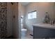 Compact bathroom featuring a tiled shower, modern toilet, and a vanity with neutral tones at 2870 W Parkside Pl, Denver, CO 80221