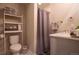 Bathroom featuring a toilet, sink with modern fixtures, and gray shower curtain at 2870 W Parkside Pl, Denver, CO 80221